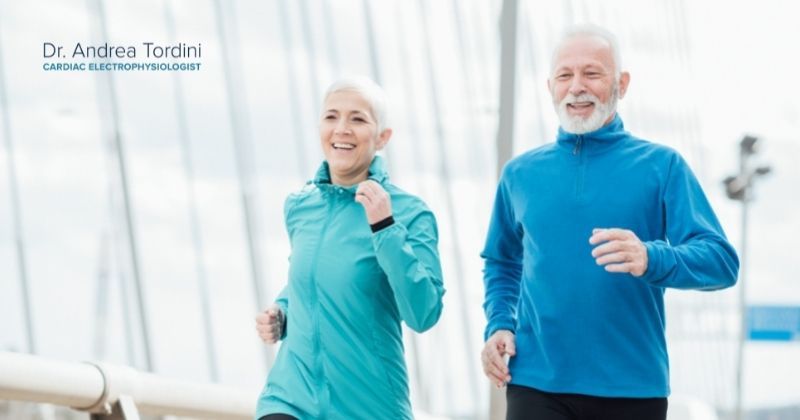 Healthy older couple jogs together as they prioritize exercise for heart health as recommended by electrophysiologist Dr. Andrea Tordini. 