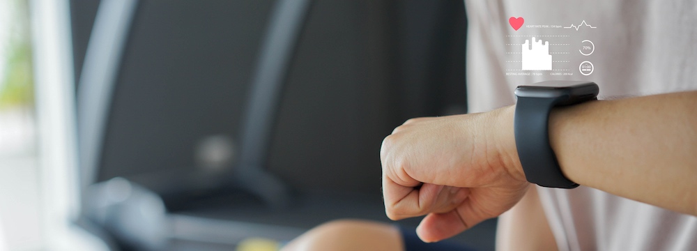 Close up young man using smart watch to monitoring about healthcare tracker with virtual display to measure heart rate and calories while workout and rest for technology and futuristic life concept