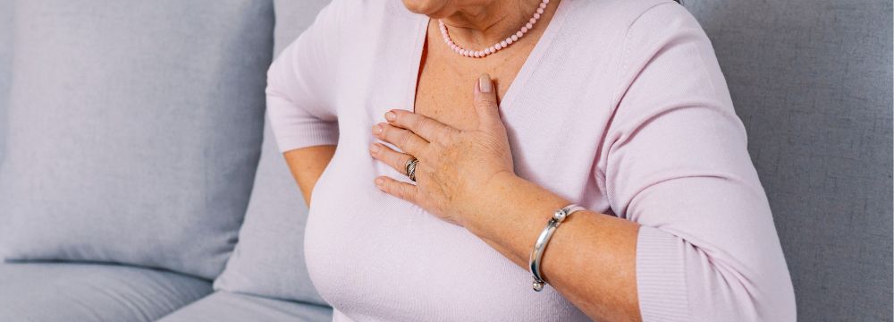 Woman experiencing Afib holding chest