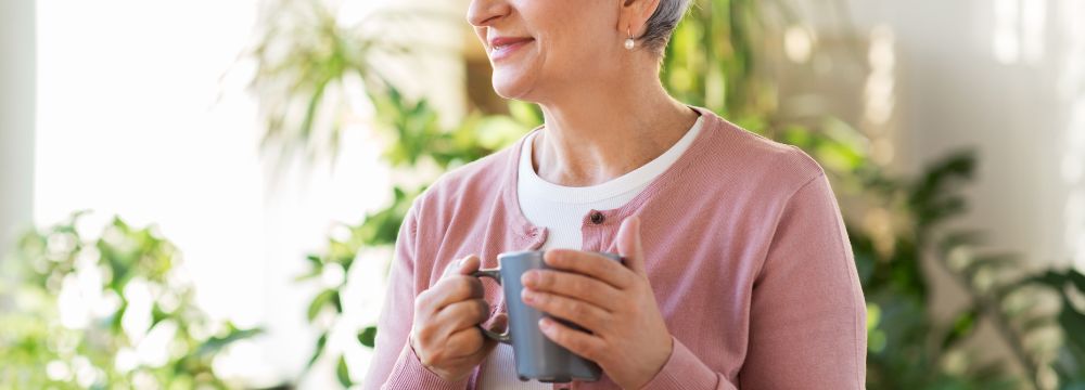 Woman sipping coffee holding coffee cup